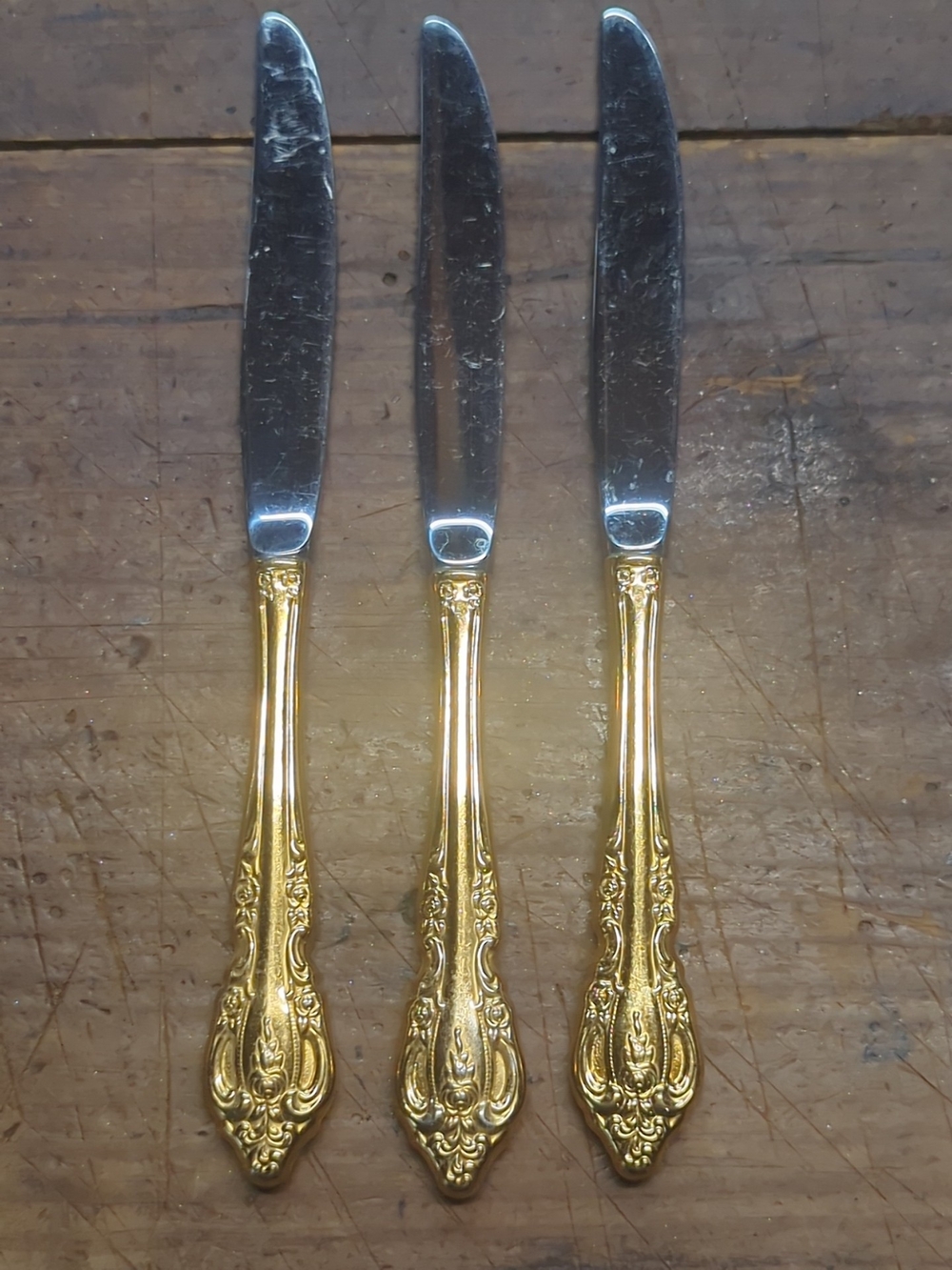Oneida Gold and Silver Ornate Dinner Knives